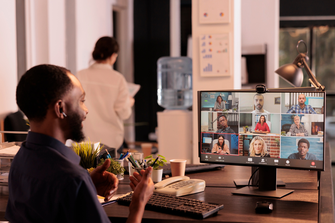 Employee discussing startup plan with remote team on teleconference